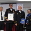 At centre, Goderich Fire Cpt. John Dobie receives Firefighter of the Year for 2011.