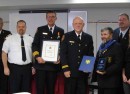 At centre, Goderich Fire Cpt. John Dobie receives Firefighter of the Year for 2011.