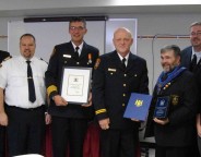 At centre, Goderich Fire Cpt. John Dobie receives Firefighter of the Year for 2011.