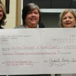 Elizabeth Bundy-Cooper, left, and Cathy Cove, right, who are co-editors of Not Like Any Other Sunday, present a cheque from book sales to Shelley Dorey, who is executive director of Victim Services of Huron County.