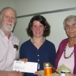 Tony McQuail presents a cheque from the NFU to Marion Studhalter, winner of the Paul Beingessner Award for Excellence in Writing, while Thea Trick holds the gift basket of local food.