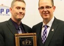 Const. Patrick Armstrong receives the Bill Elliott Member of the Year 2012 award from Jim Christie, who is president of the Ontario Provincial Police Association.