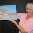 Bonnie Sitter holds a photo of an elm tree she fondly calls The Grand Old Lady.