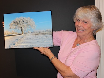 Bonnie Sitter holds a photo of an elm tree she fondly calls The Grand Old Lady.