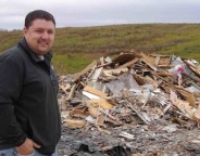 Paul Sherban, who is site supervisor of the Mid-Huron Landfill Site, stands by the piles of shingles and wood in this 2011 file photo.