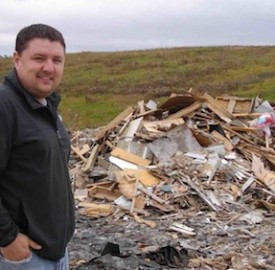 Paul Sherban, who is site supervisor of the Mid-Huron Landfill Site, stands by the piles of shingles and wood in this 2011 file photo.