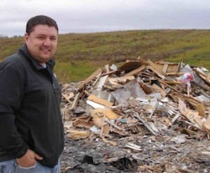 Paul Sherban, who is site supervisor of the Mid-Huron Landfill Site, stands by the piles of shingles and wood in this 2011 file photo. 